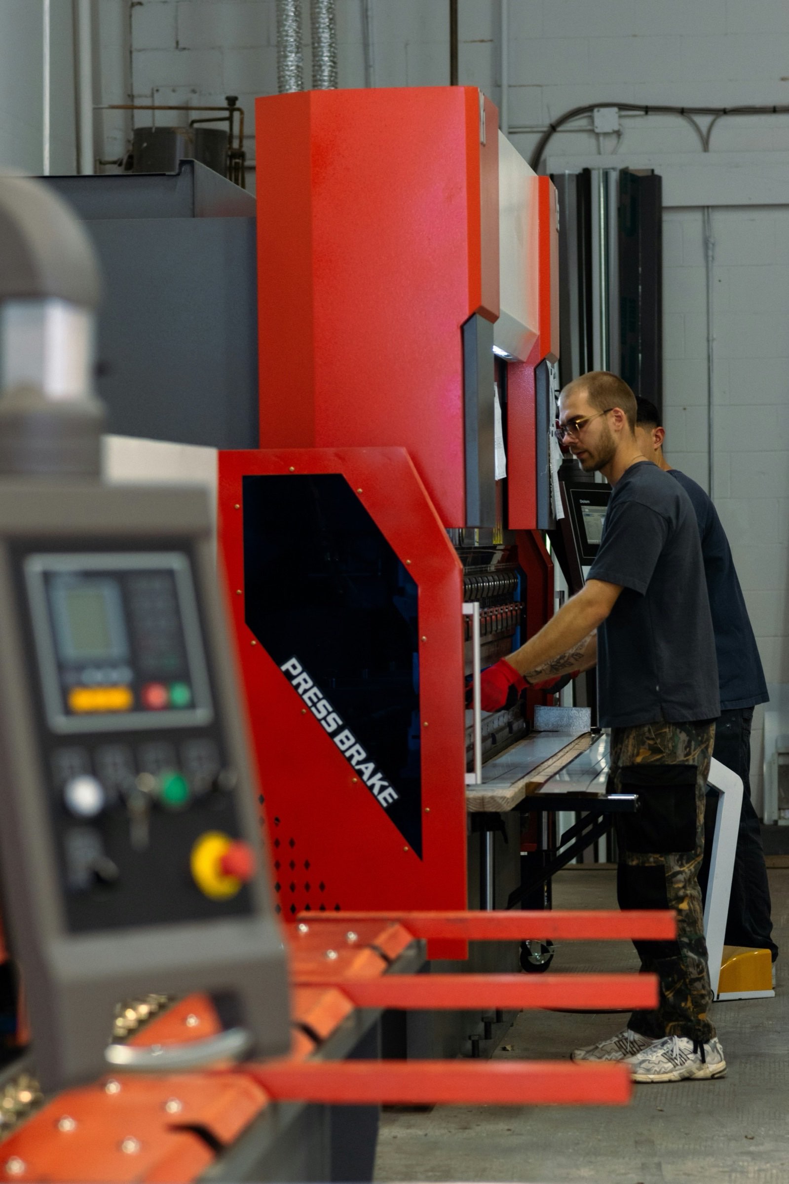 Operator running a press brake on the shop floor